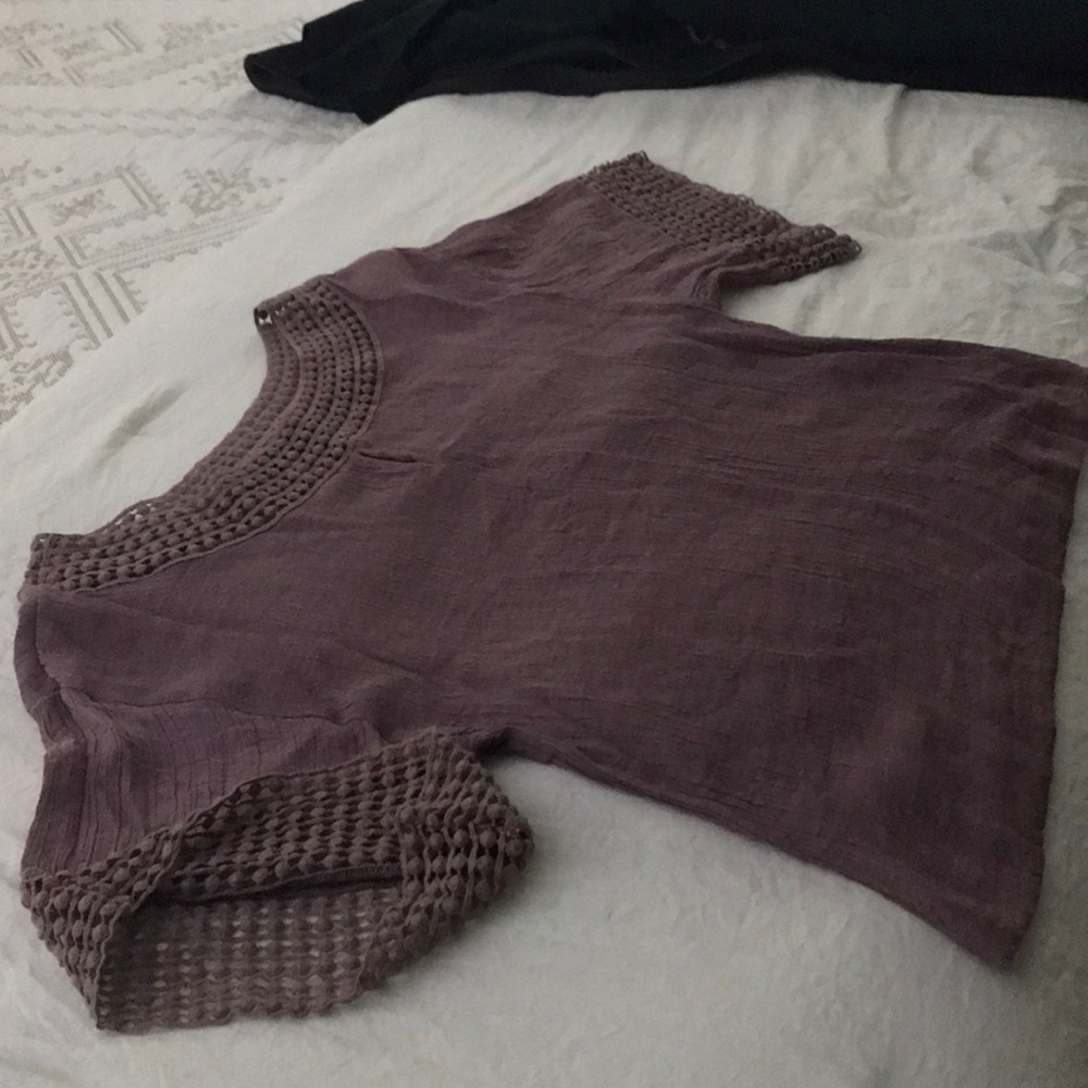 Gauze top with fun detailing around neck and arms.